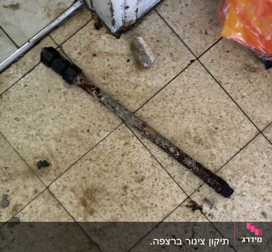 מוט חלוד על רצפה ליד דלת